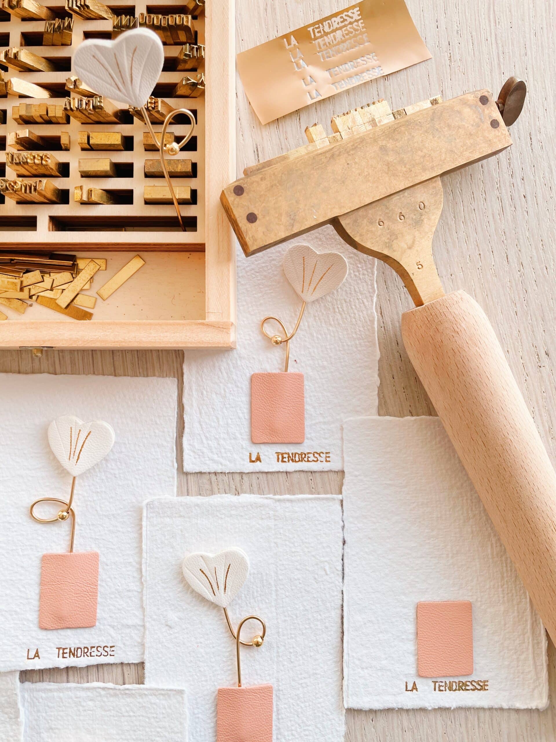Grigris Fleur d’Amour en cuir ivoire sur cartes artisanales dorées “la tendresse”