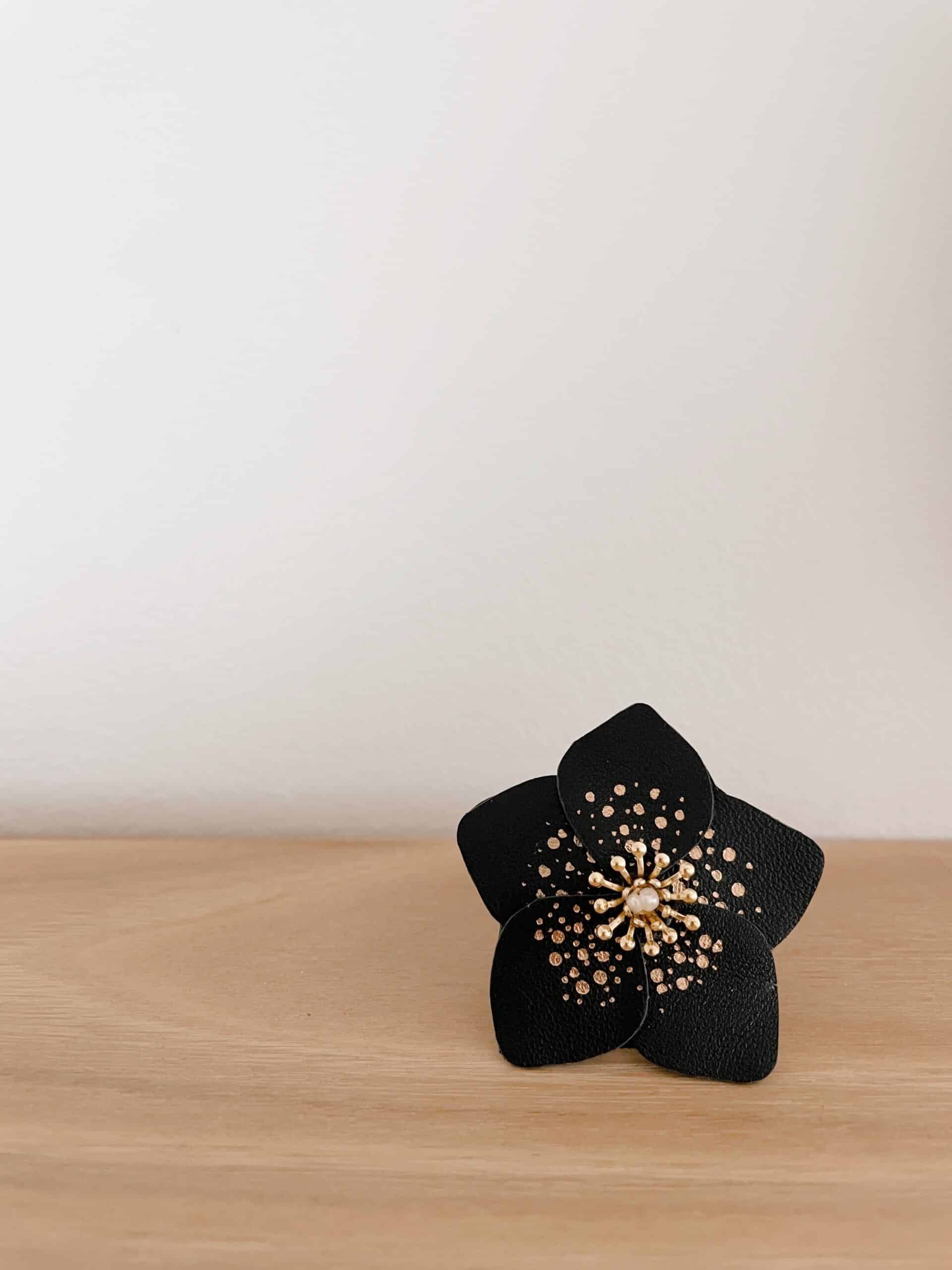 Broche Hellébore – rose de Noël noire en cuir surcyclé et dorure à chaud © Du vent dans mes valise Broche rose de Noël en cuir façonnée à la main, modèle Hellébore – création artisanale