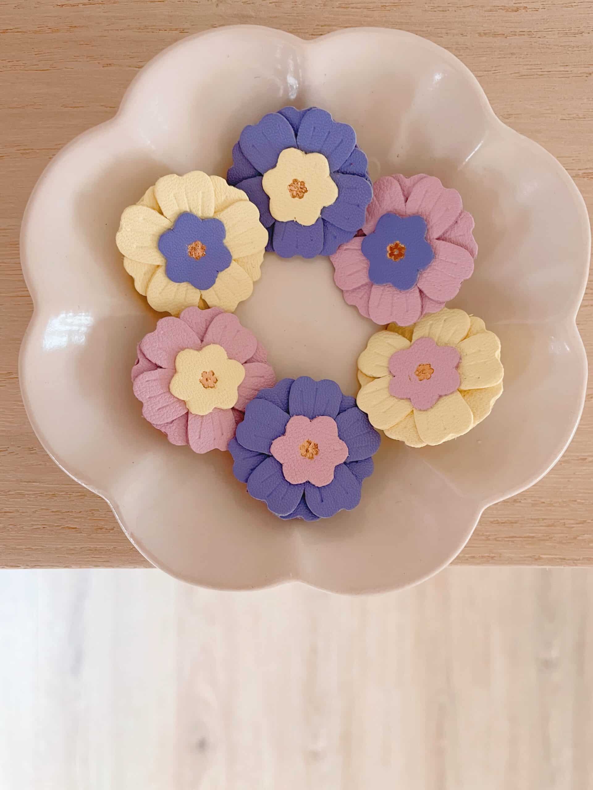 Broches Primevère – variations © Du vent dans mes valises Broches Primevère en cuir surcyclé, pièces uniques, variations de couleurs